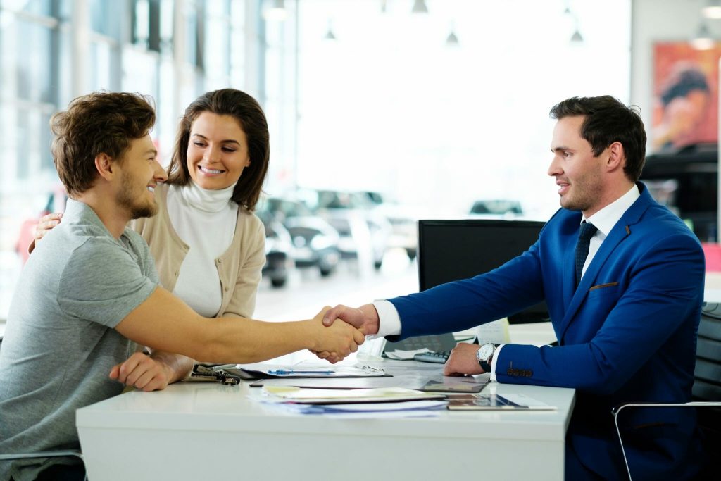 Businessman making a deal with a couple